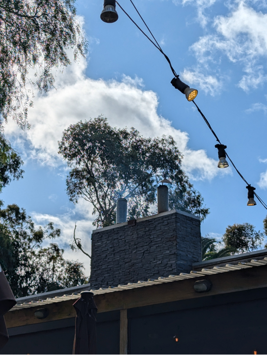 Building chimney emitting wood smoke